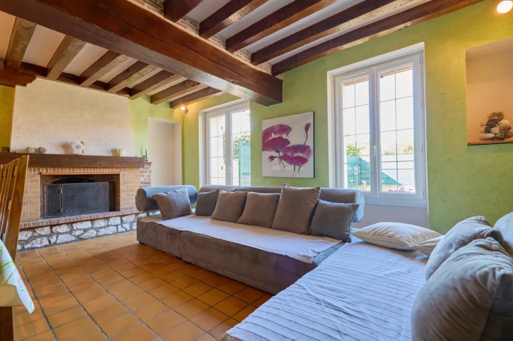 Vue d'ensemble du salon avec cheminée et canapé